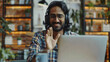 © Trendy Graphics - Young Indian man sitting at desk wearing headphones greets teacher start video call lesson to gain new knowledge, learn language, studying online, using laptop and modern videoconference application
