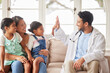 © peopleimages.com - Kids, mom and doctor with high five in home for healthcare service, medical advice or good news. Happy, girl and mother with gesture of pediatrician for test results, healing or success in house call