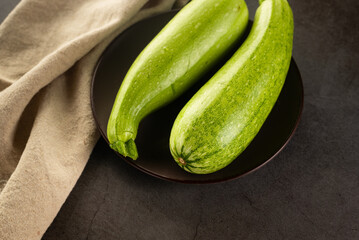 Fresh young zucchini on Dark Table - Summer Harvest