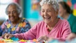 © fotogurmespb - '' nursing home staff engaging residents in a craft activity with colorful materials and bright smiles