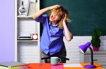 Wall Mural - Angry female teacher or college tutor in classroom. Teachers job. Stressed university student girl near chalkboard. High school. Education and knowledge. Back to school. Hard test or exam in college.