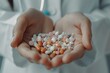 © ylivdesign - Doctor is holding a handful of colorful prescription pills in her hands