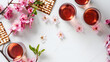 © Iqra Iltaf - Matzo wine and pink flowers apple tree for passover celebration top view flat lay