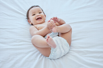 Wall Mural - Happy, laughing and above of baby on bed in home for child development, wellness and growth. Family, childhood and young infant in bedroom to change nappy with smile, playing and relax in house