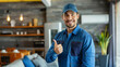 © Cadengo - In a modern interior setting, a smiling technician in a blue uniform stands confidently beside an air conditioner unit, giving a thumbs up gesture