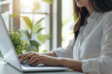 Poster - close-up image of a woman using a laptop computer keyboard