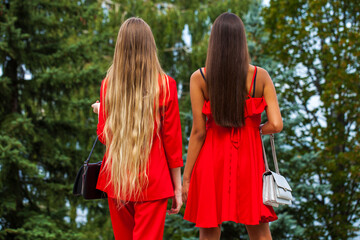 Two young girls blonde and brunette back view