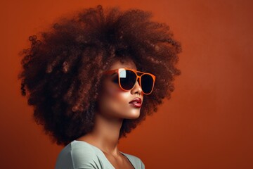 Wall Mural - Portrait of a content afro-american woman in her 40s wearing a trendy sunglasses while standing against minimalist or empty room background