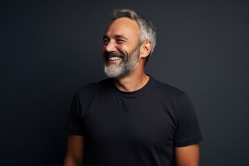 Wall Mural - Portrait of a joyful man in his 50s donning a classy polo shirt while standing against minimalist or empty room background