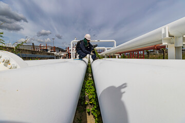 Wall Mural - Male worker inspection and measurement thickness pipeline oil and gas at check record pipeline