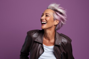 Wall Mural - Portrait of a joyful woman in her 50s wearing a trendy bomber jacket while standing against solid color backdrop