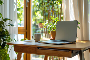 Poster - Laptop and coffee cup standing on desk with plants creating cozy home office atmosphere for freelancer working remotely
