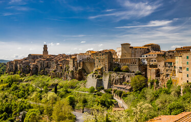 Wall Mural - A glimpse of the ancient medieval village of Pitigliano, in the province of Grosseto, Tuscany, Italy. Is known as the little Jerusalem. The old stone houses built overlooking a spur of tuff rock.