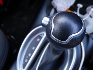 Close up detail of a gear shifter inside of a car