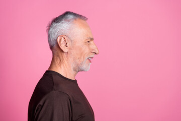 Wall Mural - Side profile of nice man with white gray beard dressed brown t-shirt look at discount empty space isolated on pink color background