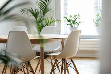 Poster - A minimalistic Scandinavian dining area with a sleek wooden table and white chairs, bathed in natural light coming from a large window