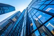 © Elmira - A low-angle view of modern office buildings with mirrored glass facades, showcasing the city's skyline reflected in the windows