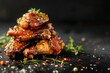 © VolumeThings - American cuisine Honey glazed fried chicken wings on black background Text space available
