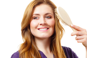 Canvas Print - Woman brushing long healthy brown hair