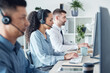 © peopleimages.com - Typing, call center and group in office, computer and man with colleagues, coworking and headset. Desk, online and research for question, inquiry and customer service, people and telemarketing