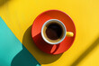 © Echelon IMG - cup of tasty african coffee on a colorful wooden table, top view