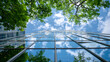 © practice  - Green building concept depicted in sustainable architecture exterior view, with a glass curtain wall framed by green trees and a vibrant blue-sky background.