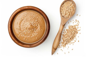 Sticker - Tahini paste and sesame seeds in a bowl on white background Overhead view