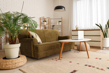 Wall Mural - Interior of living room with green sofa, table and plants