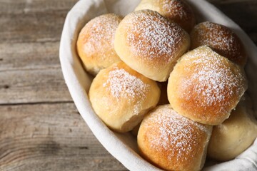 Wall Mural - Delicious dough balls in basket on wooden table, above view. Space for text