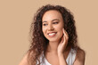 © Pixel-Shot - Happy young African-American woman with healthy moisturized skin on beige background