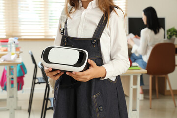 Poster - Teenage girl with VR glasses in classroom, closeup