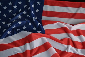 Flag of USA on black table, top view