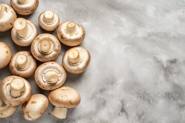 Wall Mural - Champignon mushrooms on white marble background. Top view, flat lay