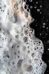 Poster - Close-up view of a foamy substance on a black background