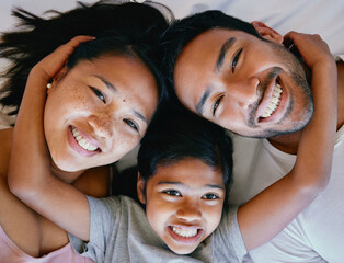 Poster - Family, portrait and top view on bed with smile for relax, bonding and break on weekend together. Woman, father and child in home with love, care and support for comfort or happiness in Philippines