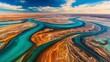 © Constantine Art - A turquoise river flows through a desert landscape, creating a colorful contrast