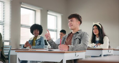 Leinwandbilder - Answer, education and student at desk of classroom in school for development, learning or study. Growth, smile and question with happy teen boy writing in class for academy, lecture or scholarship