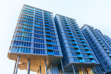 Wall Mural - Modern buildings with numerous windows reaching into the sky. Architecture with modern design in Vienna