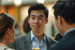 © BetterPhoto - Man engaging in a conversation at a social event, showcasing networking and interpersonal communication.