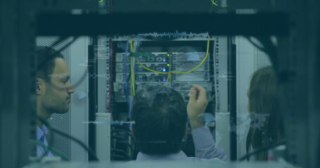 Image of data processing over team of diverse engineers working at computer server room