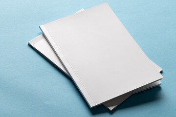 Sticker - Blank white books on a blue background, with copy space