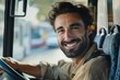© senyumanmu - Happy bus driver behind steering wheel looking at camera