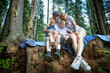 © keleny - A man, woman, and child having fun and playing in the forest or park in summer or spring sunny day