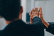 © ARMMY PICCA - Motivated successful business team giving high five, happy young students employees group join hands with senior teacher mentor, team building unity concept, help support in teamwork, close up view