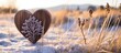 © HN Works - A charming carved wooden heart has been placed delicately amidst dry grass on a snowy backdrop, making it a perfect image for a Valentine's Day card with copy space.