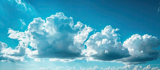 Poster - The expansive blue sky adorned with fluffy white clouds, providing a serene backdrop for copy space image.