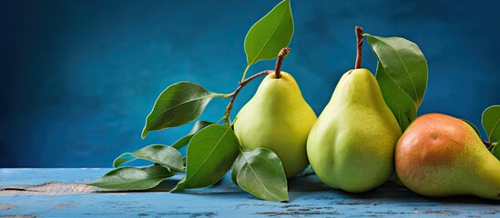 Poster - Fresh pears and leaves are set against a blue backdrop, ideal for a 