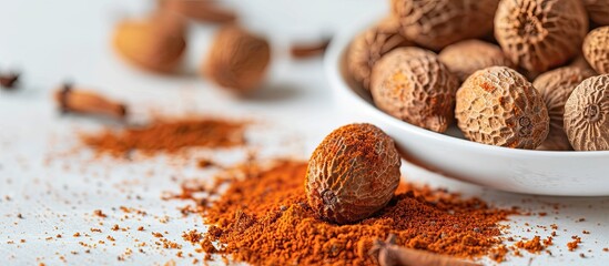 Sticker - Kerala spices: A stunning mace of nutmeg, vivid orange, and aromatic, displayed on a white surface with copy space image.