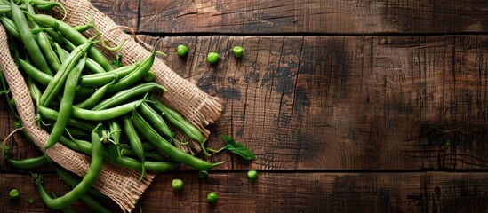 Poster - Fresh green beans arranged on a rustic tabletop with a copy space image in the background, perfect for a healthy meal or snack.