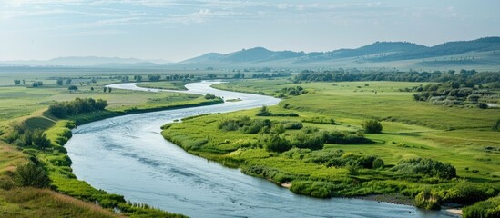 Poster - A river meandering with a scenic view on one side and a vast and appealing blank space to be used for display or advertisement on the other side.